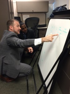 AP Program Manager Charles O’Brien illustrates his interpretation of an updated Strategy Map while AP Analyst EJ Hunt takes note.